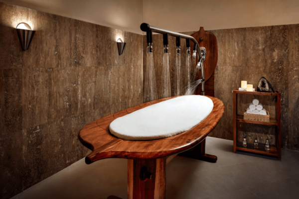 shower spa treatment bed with stone surrounding room